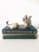 gray and white rabbit figurine on green book