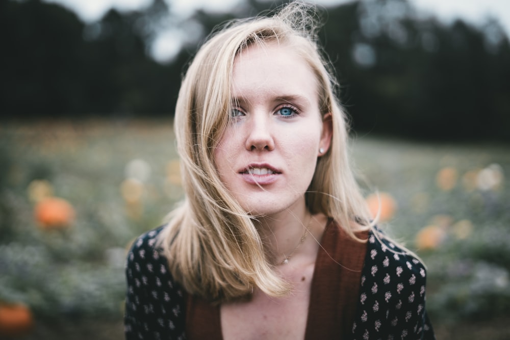 woman wearing brown and black top selective focus photography