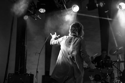 A striking black-and-white photo capturing Pablo Malpica deeply focused during a live concert setup.