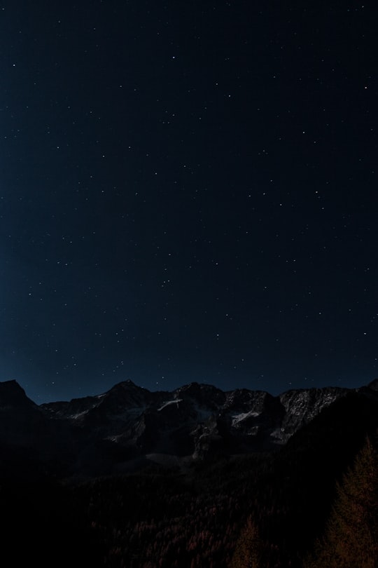 gray and brown mountains under starry night photo in Rieserferner-Ahrn Nature Park Italy