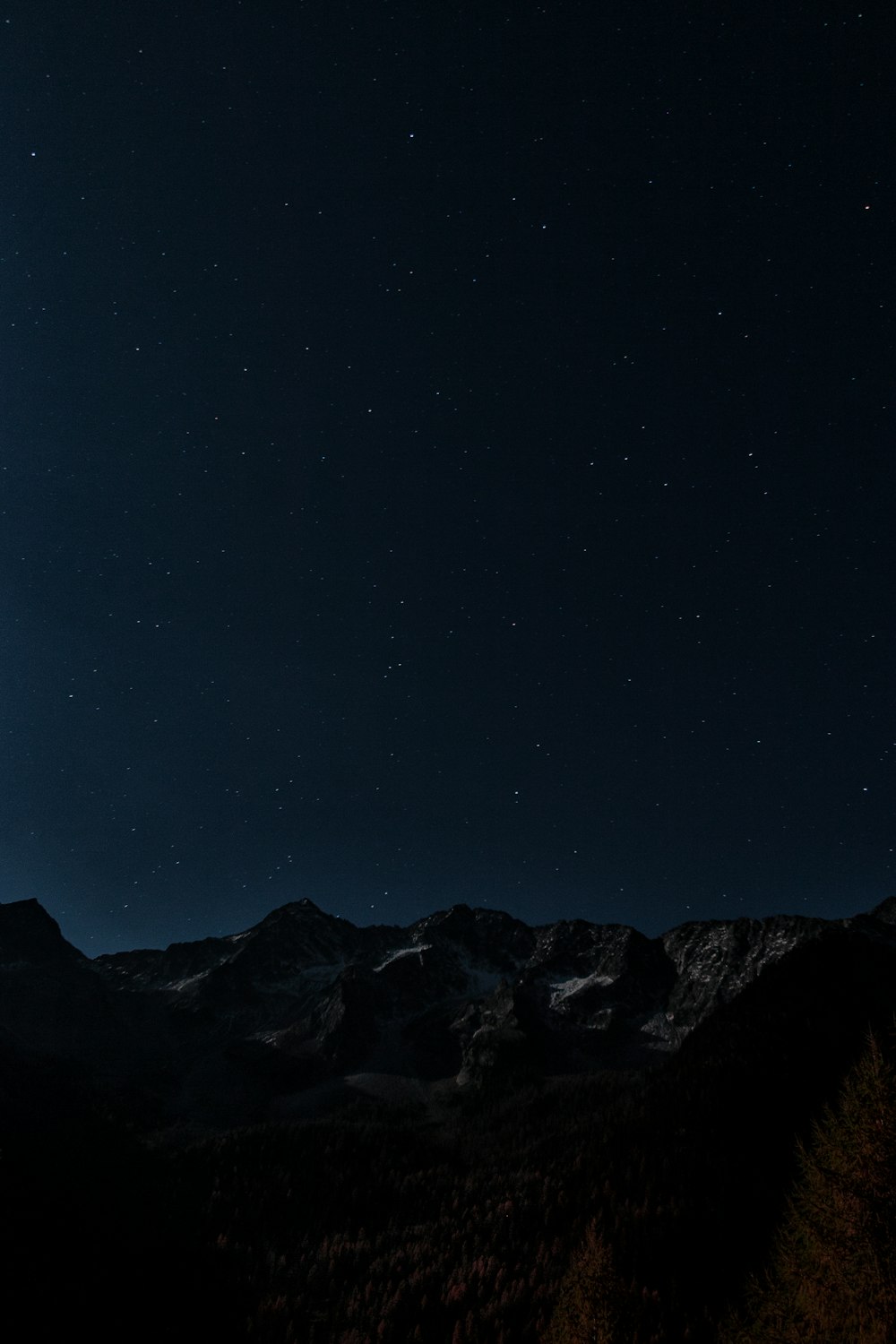 星空の夜の写真の下の灰色と茶色の山々