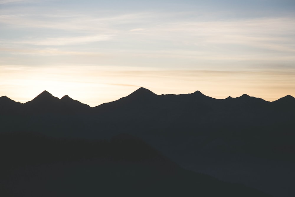 silhouette of mountain range during sunrise/sunset