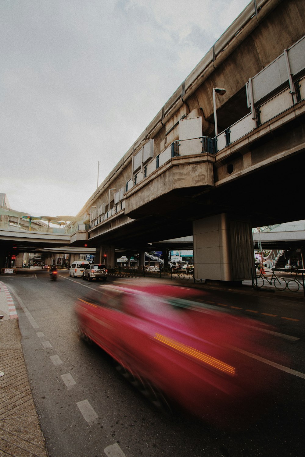 time lapse photo of a car on road near building