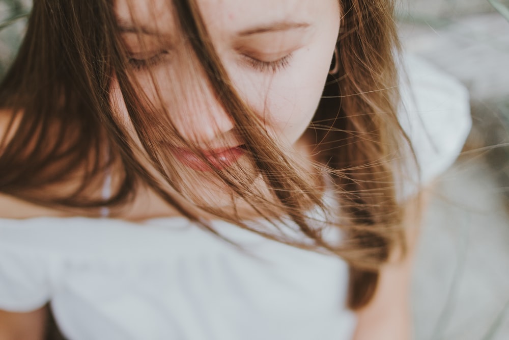 woman with white shirt with eyes close