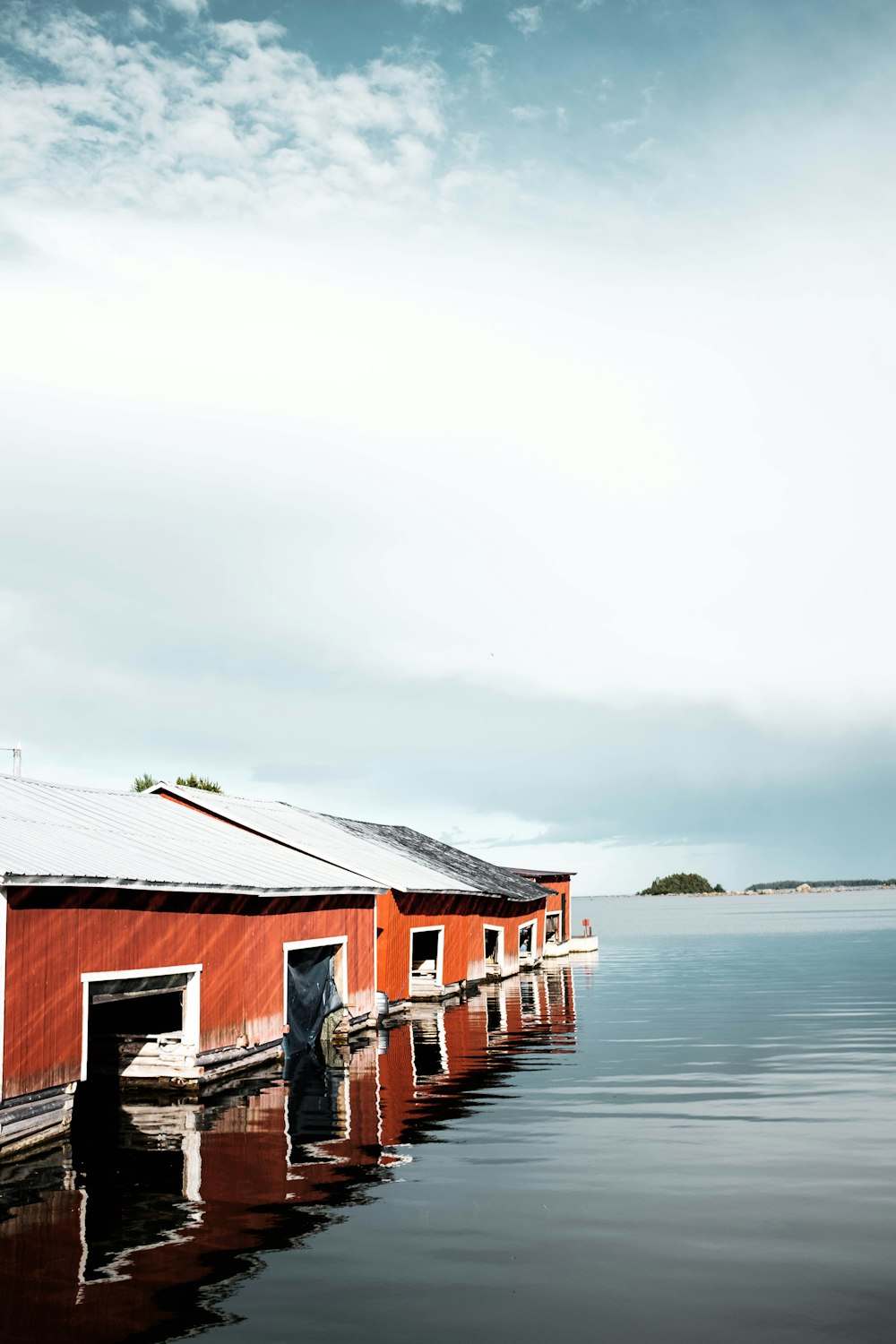 brown houses surrounded by body of water during daytime