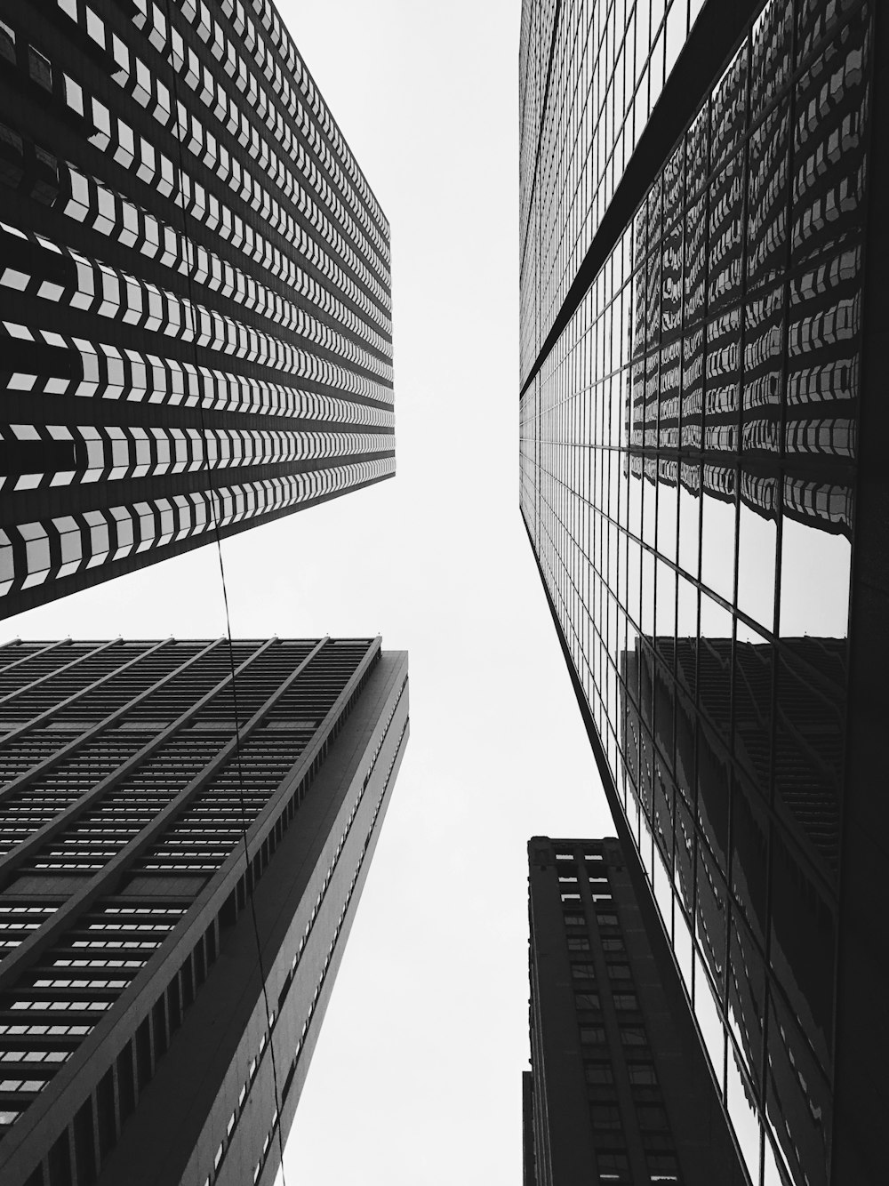 low-angle grayscale photo of high-rise building