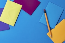 assorted-color paper and brown wooden pencil