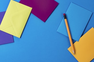 assorted-color paper and brown wooden pencil