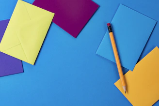 assorted-color paper and brown wooden pencil