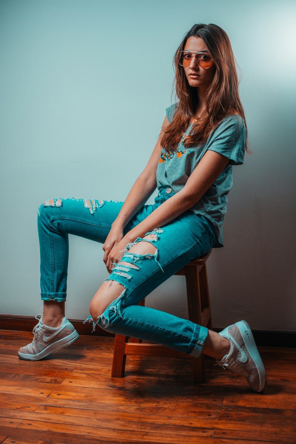 woman sitting on stool chair posing for photo