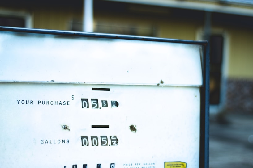 A close-up of a fuel pump with a digital display showing transaction details.