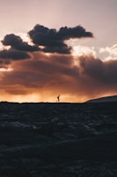 landscape photo of person walking on horizon