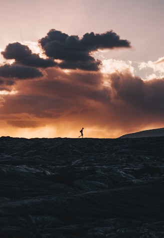 landscape photo of person walking on horizon