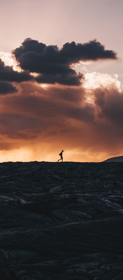 landscape photo of person walking on horizon