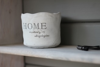 white Home printer vase on white wooden board