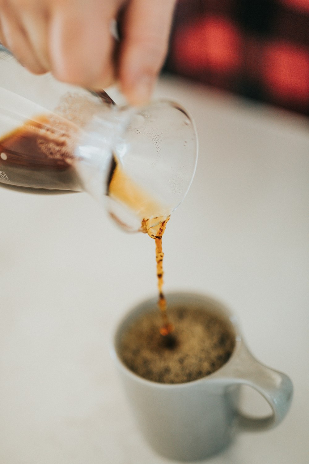 person pouring coffee on gray up