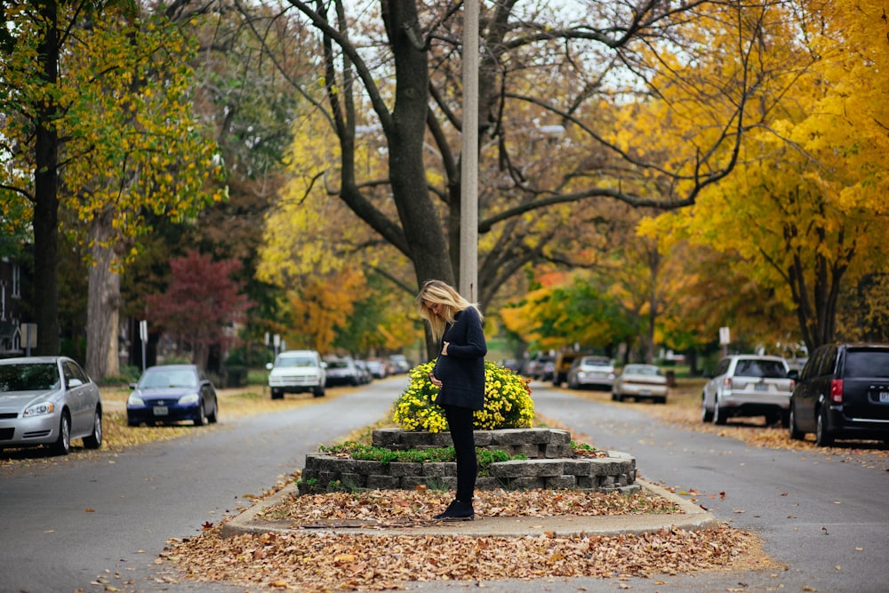 woman standing near tall tree during daytime