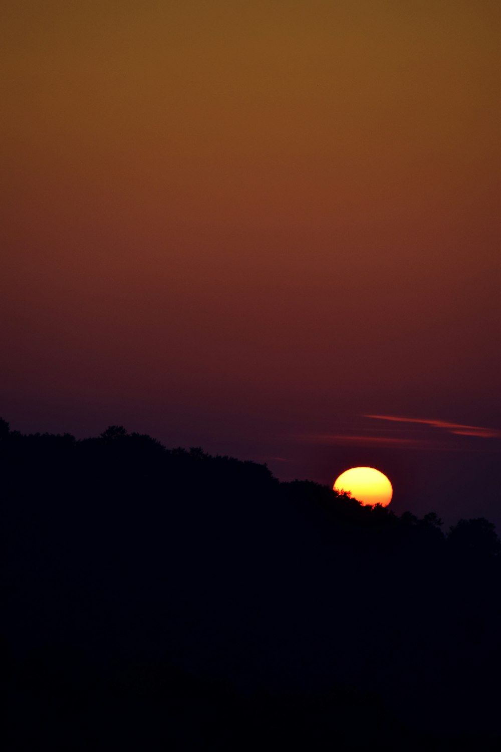 silhouette of mountain showing full moon