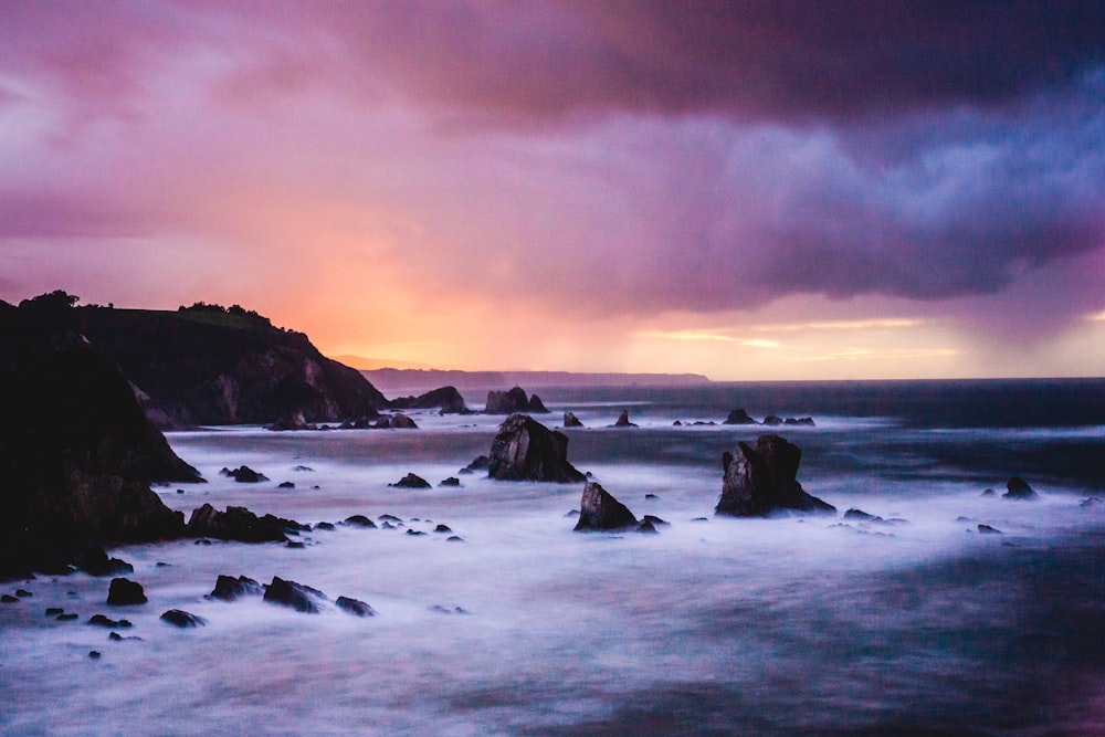 time-lapse photo of sea and rock formation