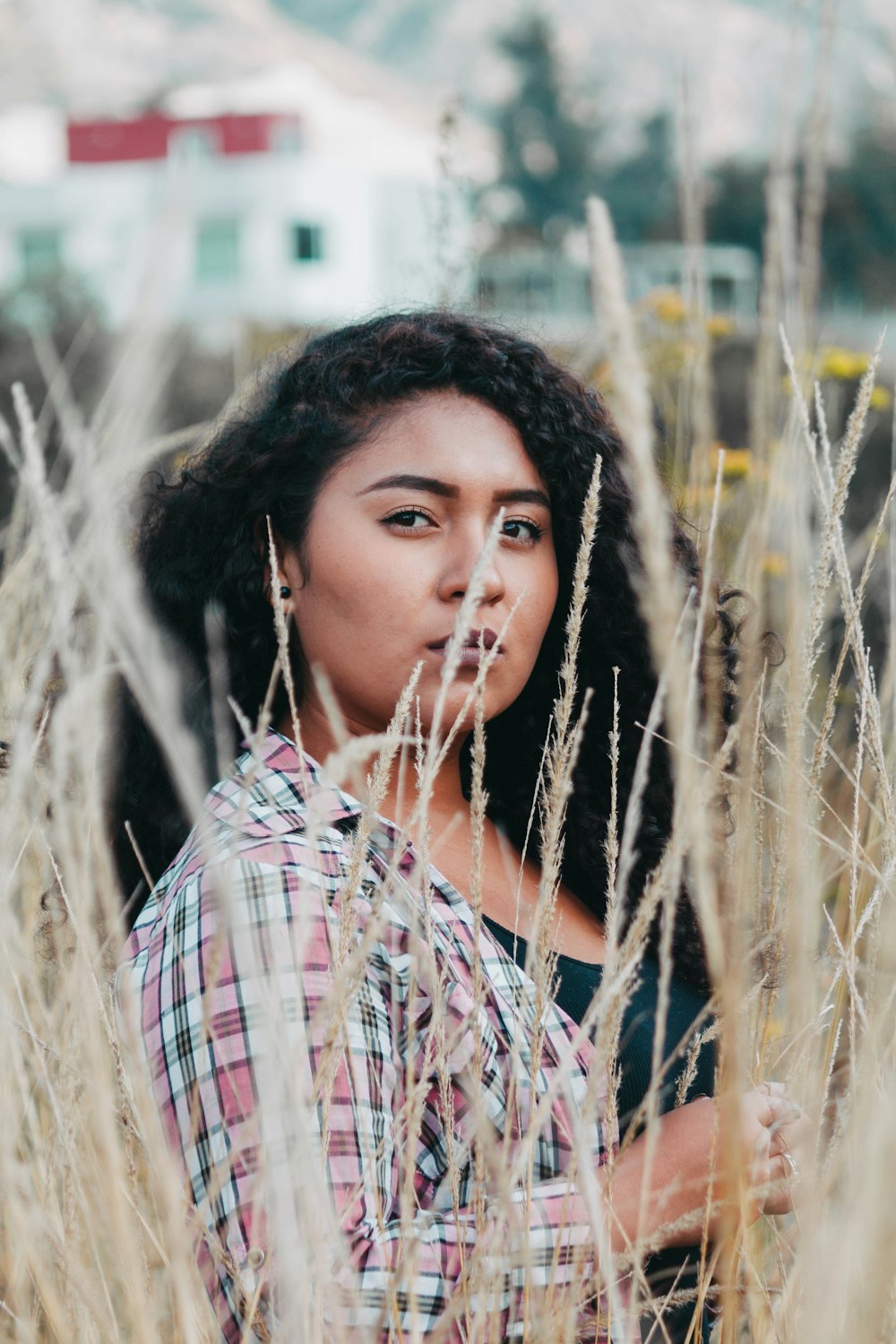 woman surrounded by plant during daytime