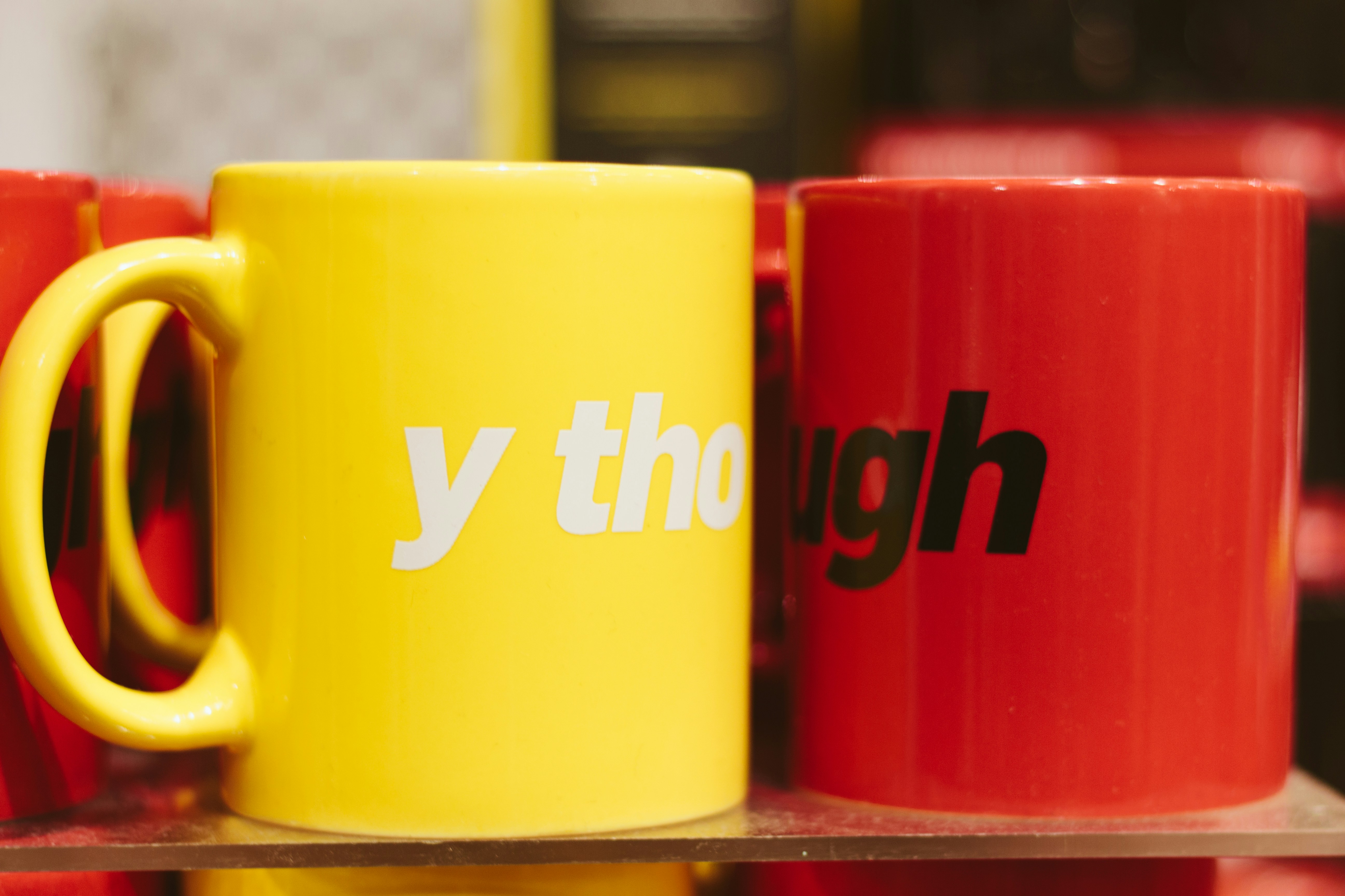 two yellow and red ceramic mug