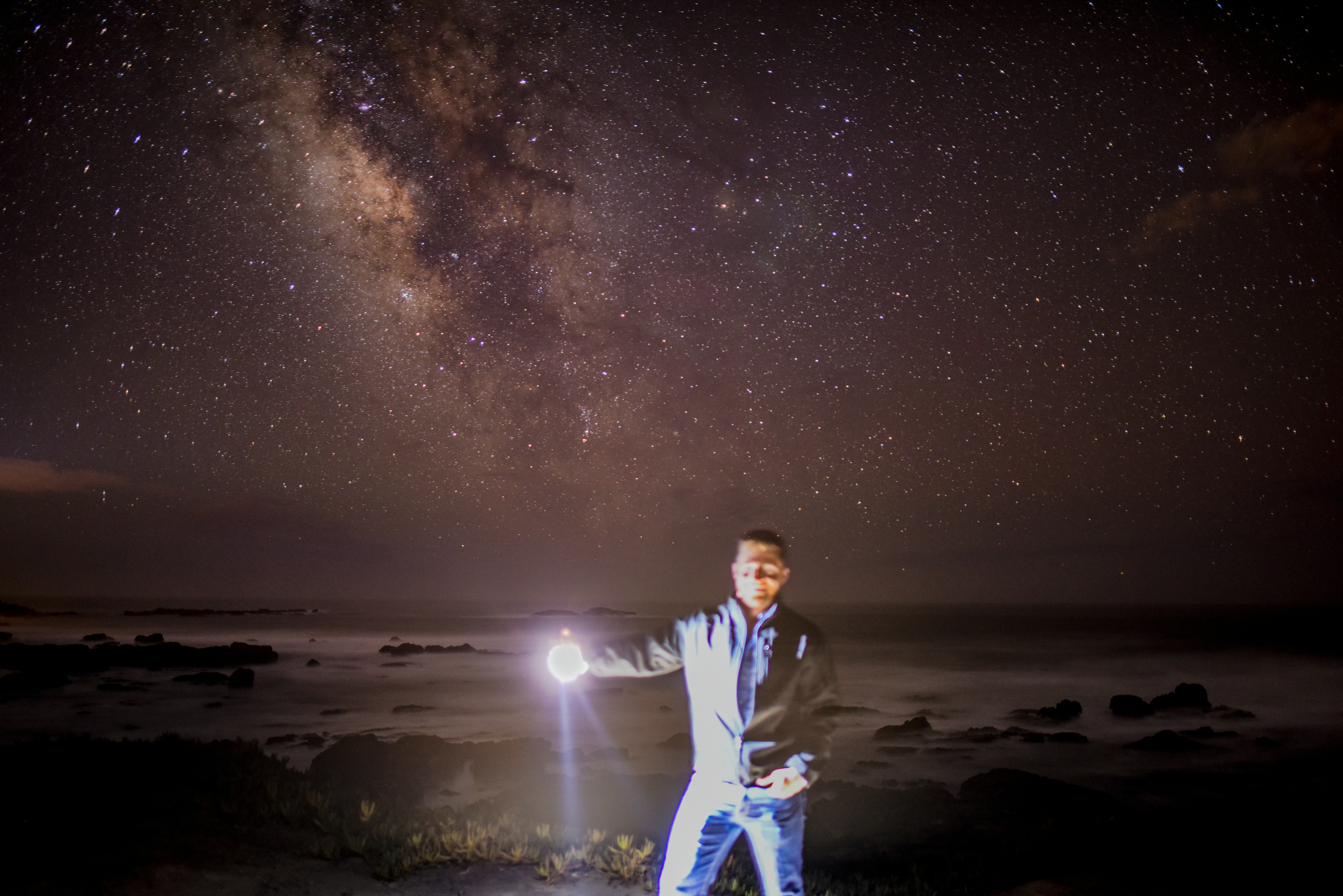 man holding flashlight illuminated teams background