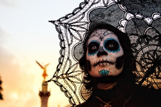 person with skull face paint and umbrella