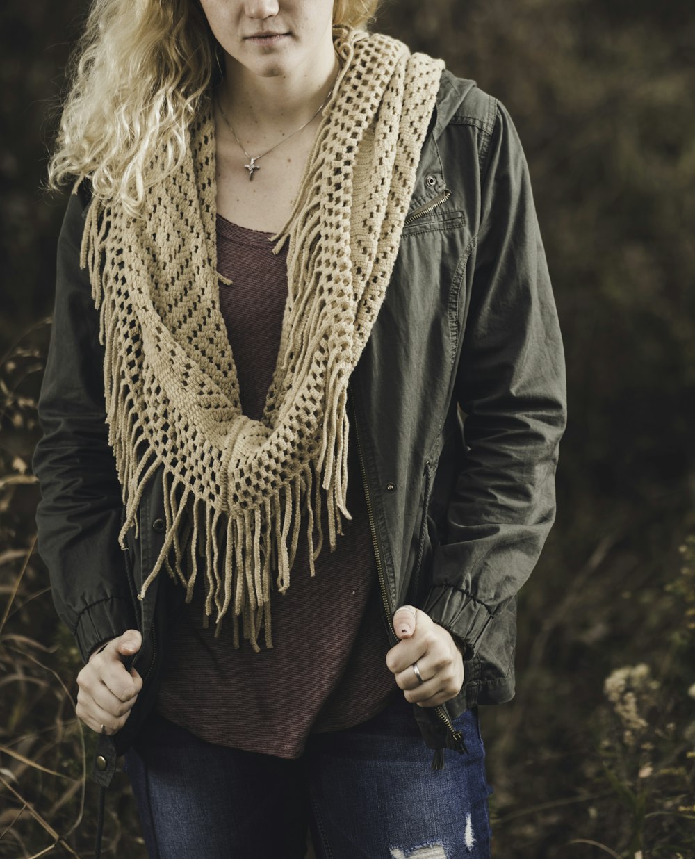 selective focus photo of woman standing of dried grass