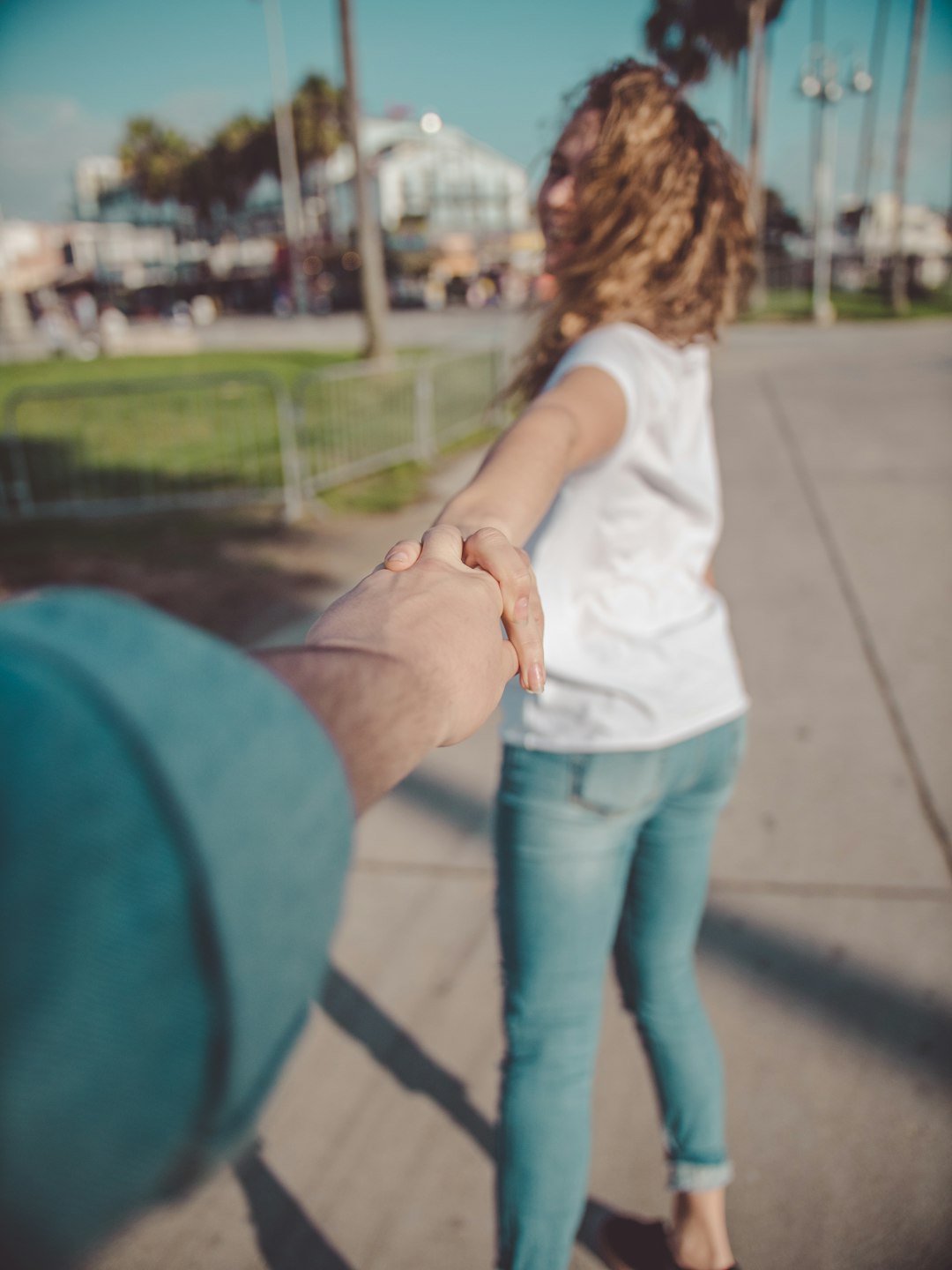 woman holding hands with person during daytime