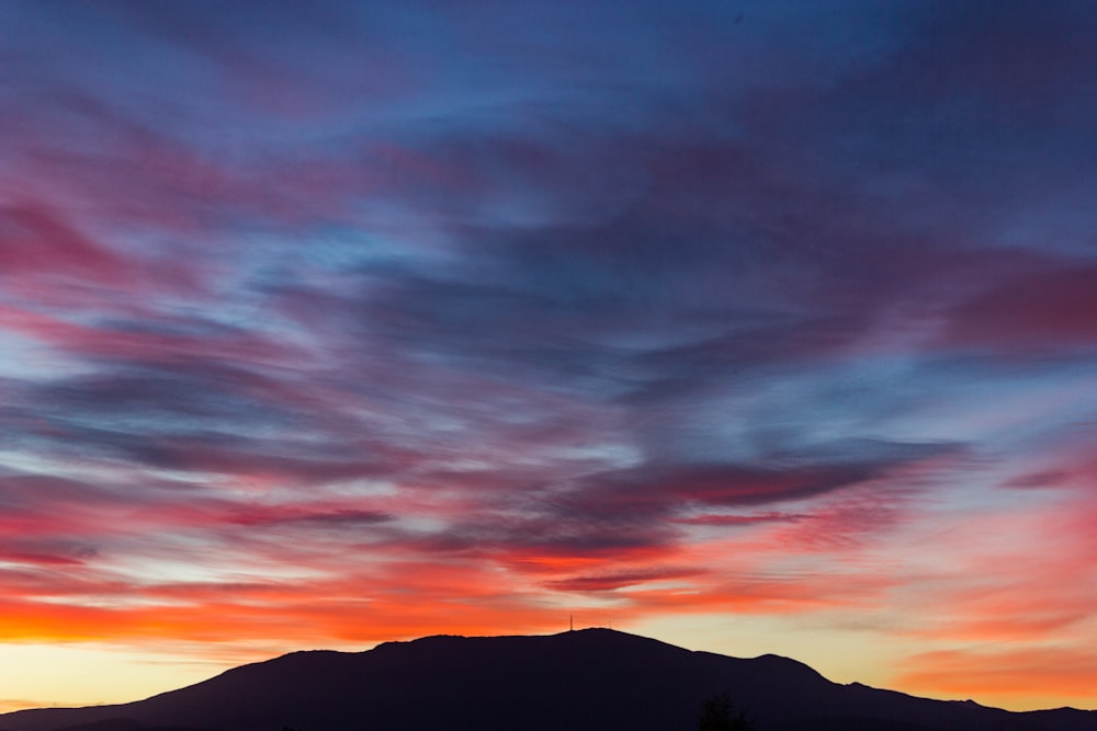 silhouette of mountain at sunset