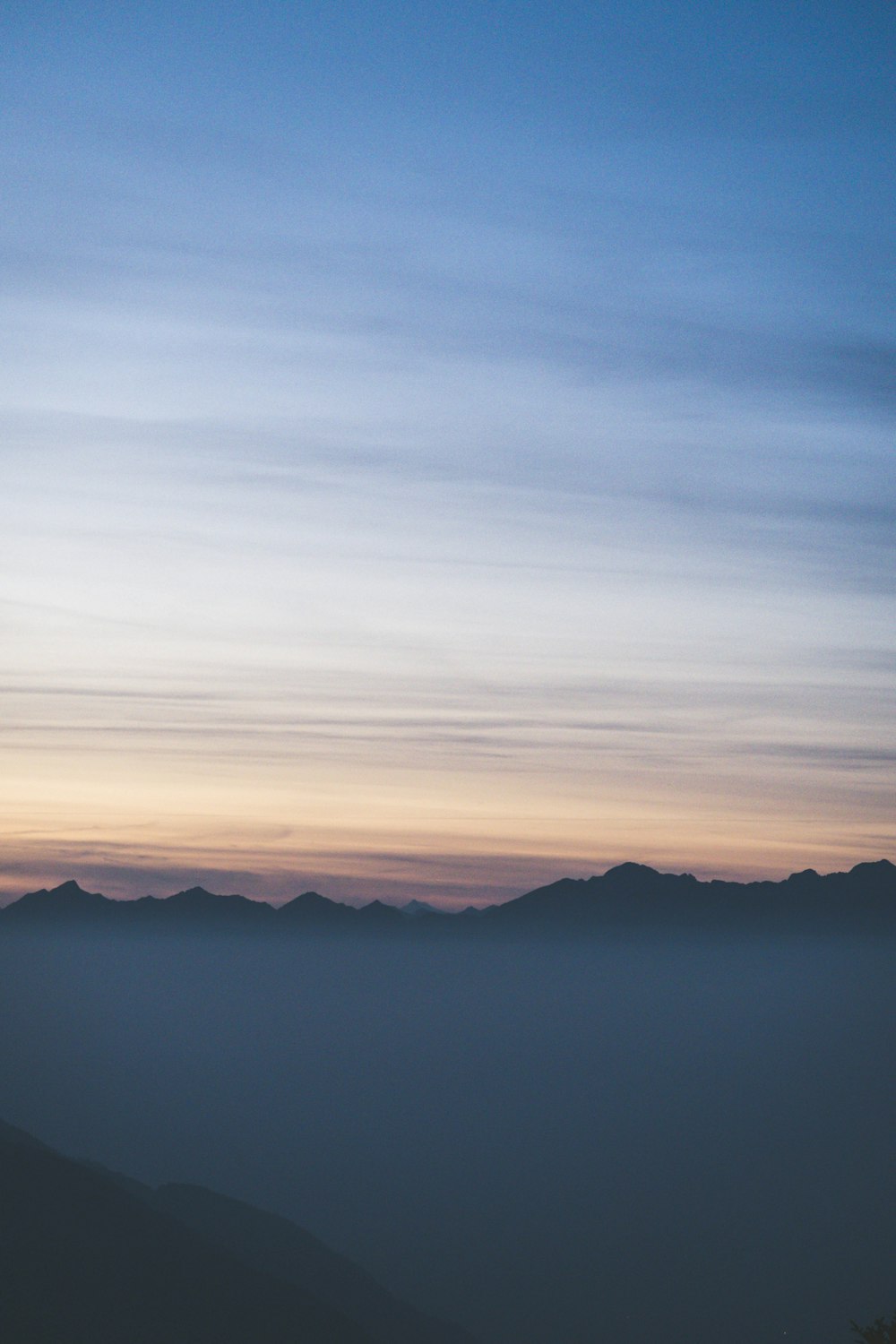 silhouette of mountain under orange sunset