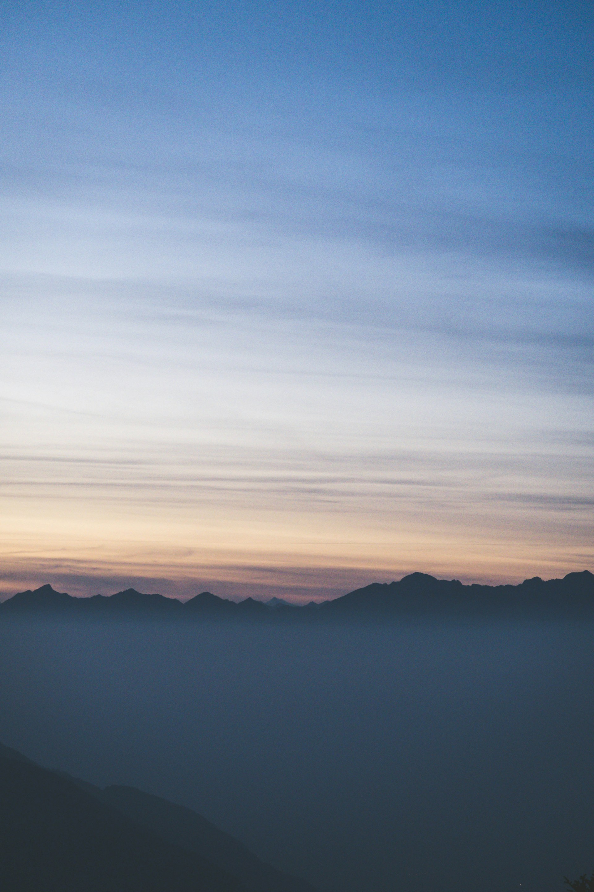 silhouette of mountain under orange sunset