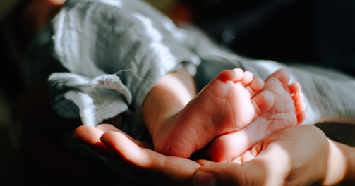 person holding baby feet