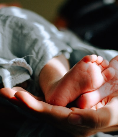 person holding baby feet