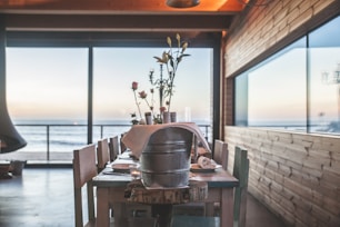 Sunlit dining area with rustic wooden table and sea views.