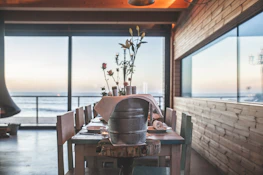 A rustic table set with fresh seafood and local wine, framed by soft natural greenery.