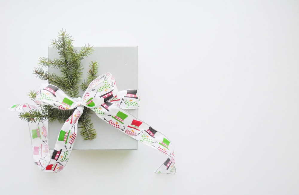 green pine tree leaves tied with multicolored fabric strap ribbon