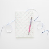 A notebook cover personalized with a child's name in fun, hand-drawn lettering surrounded by colorful shapes.