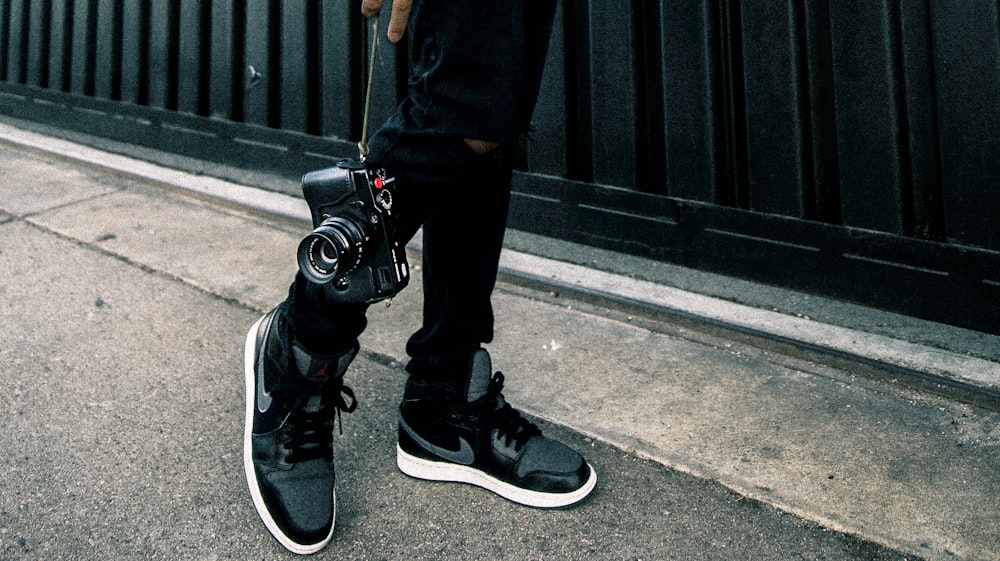 person holding black SLR camera