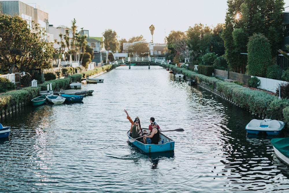 two person on blue boat during daytime