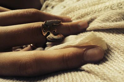 Artistic shot of stacked rings on a textured fabric backdrop highlighting intricate details.
