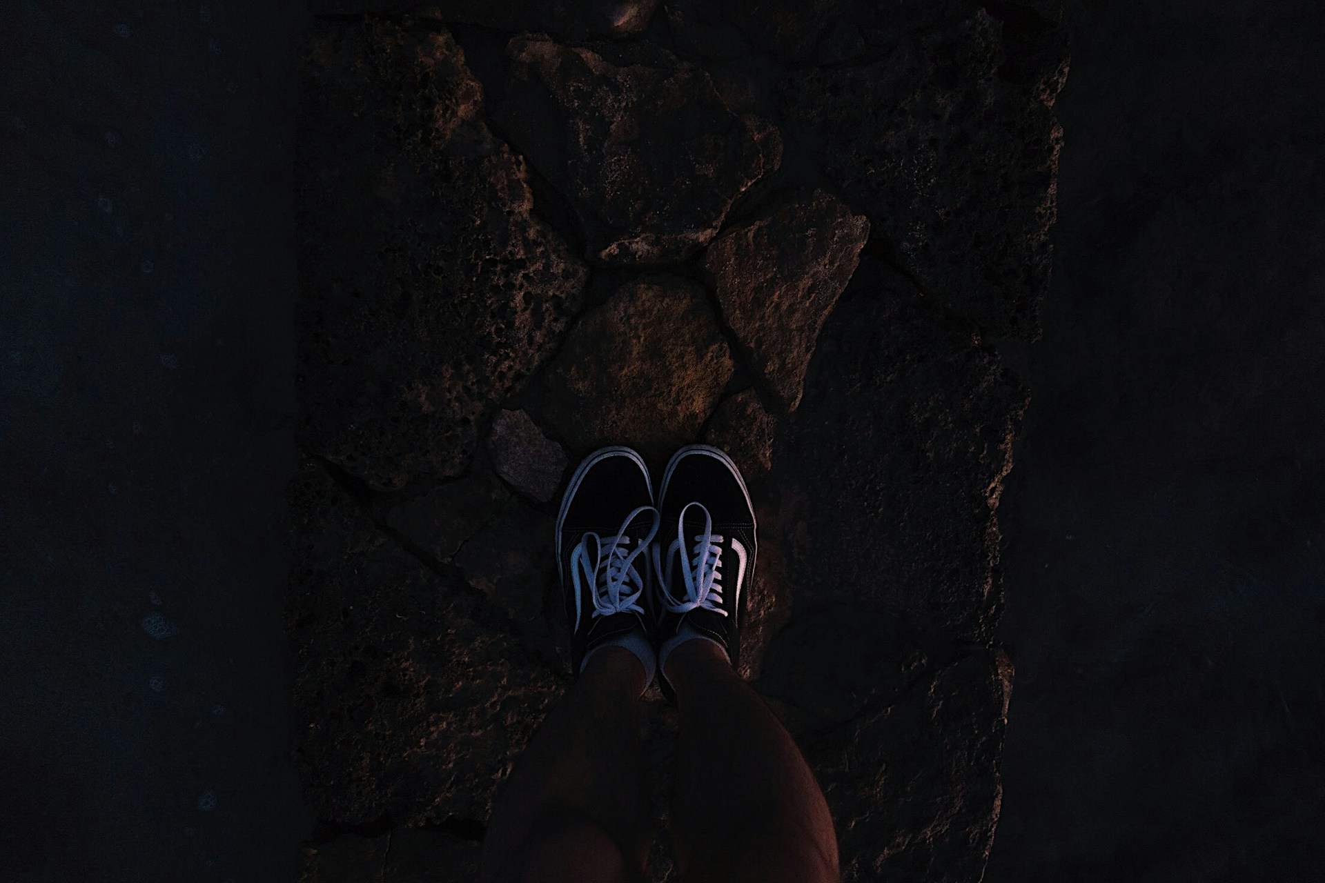 a person standing on a rock with their feet up