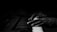 Close-up of hands playing a piano keyboard in a softly lit studio.