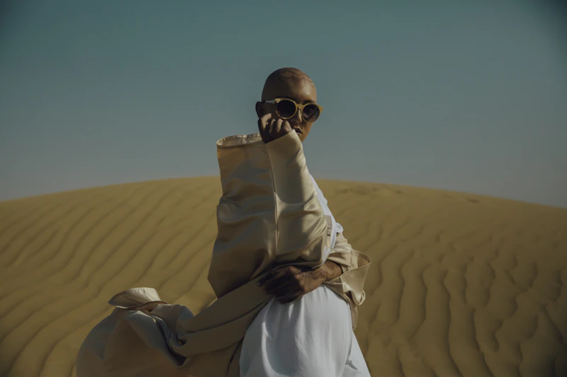 A traveller wrapped in desert clothing on a dune