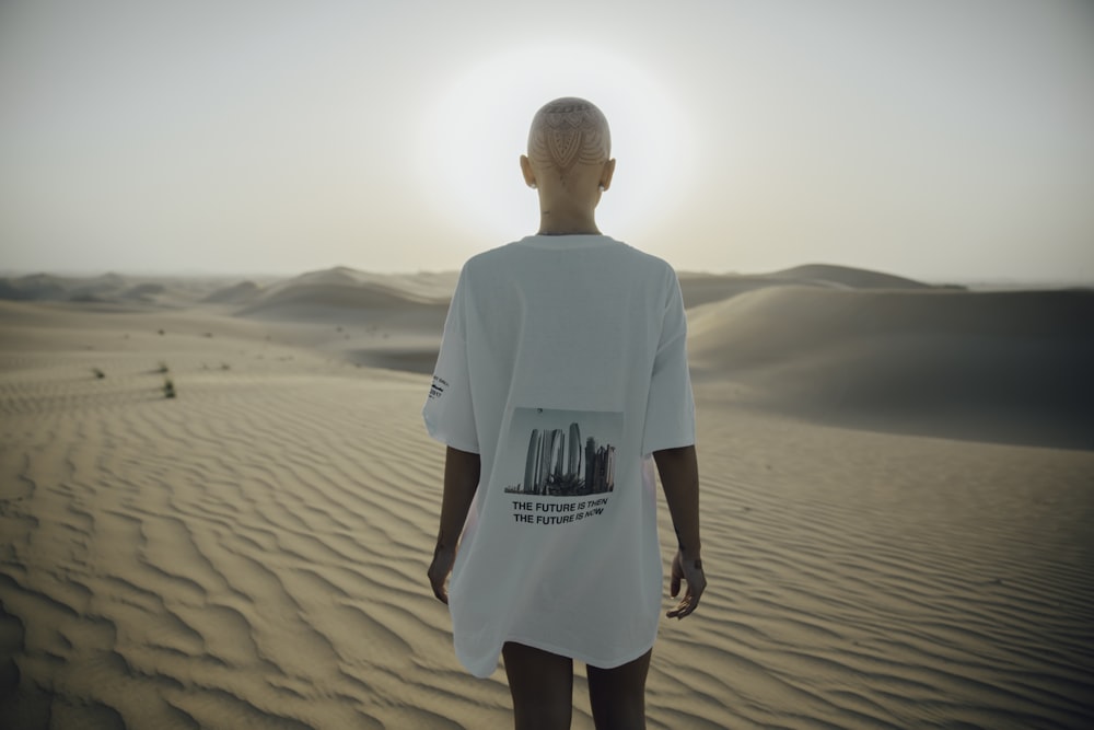 photography of woman standing on desert