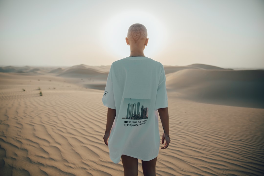 photography of woman standing on desert