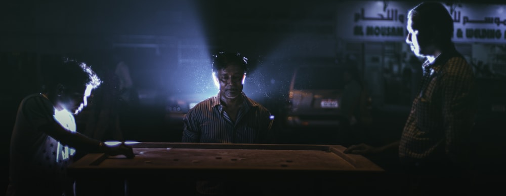 man standing on side of table film still