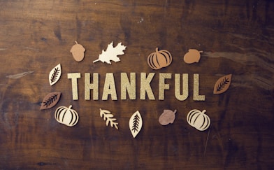 brown wooden board with letters spelling thankful