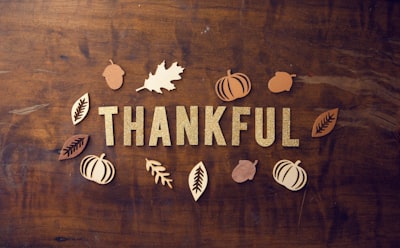 brown wooden board gratitude teams background