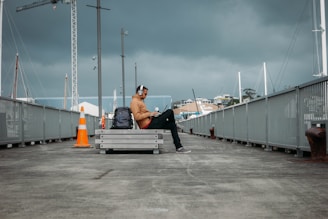 person sitting on bench wearing headphones